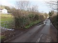 Stream flowing over the road near Milton Hill