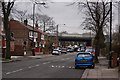 A cluttered Urmston Lane with the M60 bridge ahead