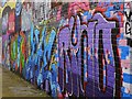 NZ2563 : Graffiti Wall on Maiden's Walk by Andrew Curtis