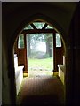 Looking out of Up Marden church towards the footpath