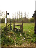 TM1349 : Footpath sign and stile by Chris Holifield