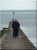 SX9676 : Dawlish - strolling on the breakwater by Chris Allen