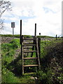 Steps over the fence as the footpath crosses the railway