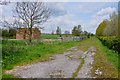 Farm access track with straw bales and cattle crush