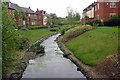 Brook flowing through a new housing estate