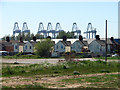 Houses dwarfed by cranes in Felixstowe docks