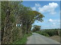 Woodland and sign to public footpath on Soldonmoor