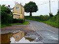 Cottage reflected in a large puddle