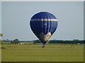 TL3998 : Hot air balloon flying very low near Westry, March by Richard Humphrey