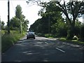 Tree lined A418 near Bigstrup Farm