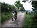 SO3995 : Riders on the lane into Coates by Richard Law