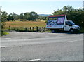 Advertising van parked at the edge of a field,  Weston-super-Mare