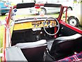 The interior of a red Triumph Herald