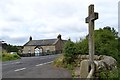 Cottage and cross at Heavenfield on the B6138