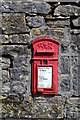 Old post box set in a limestone wall in Grindlow