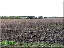 TM3895 : Looking over recently ploughed fields towards Church Farm by Helen Steed