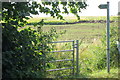 Gate onto overgrown path to the M1