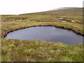 NN8586 : Crater-like pool on saddle south of Carn an Fhidleir Lorgaidh above Glen Feshie, Aviemore by ian shiell