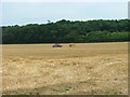 TG2339 : Farm 4x4 beside a rather sad looking straw bale by Dave Fergusson