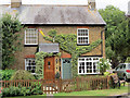 Topiary Olympic Flame on a Wilstone Cottage