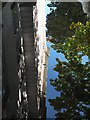 University building reflected in puddle