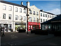 J2664 : Shops on the north side of Lisburn Square by Eric Jones