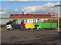 Car park, colourful lorries and a DLR train