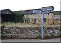 Signpost and old farm building in Carr