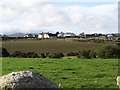 View south-westwards across farmland to a new housing estate on Ballyveaghbeg Road