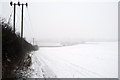 Snowy field by the byway with Dunstable Road in the distance