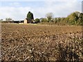 Farm buildings and ploughed field