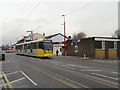 SJ9098 : Metrolink Tram on Manchester Road by David Dixon