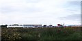 View across wasteland to stores at Sprucefield Park