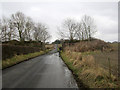 NT9550 : Country road and former railway bridge near Longridge by Graham Robson