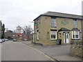 The High Street passes the Cock at Roade