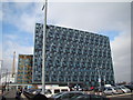 View of an office block next to the Emirates Air Line car park from the path leading to the O2