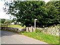 Wooden signpost alongside a bridge over Cwm Cwy near Talybont-on-Usk