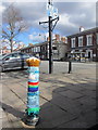 A crocheted bollard cover in Main Street, Frodsham