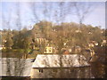 Chalford glimpsed through the trees, from the train