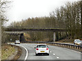 SD5185 : Footbridge and Rail Bridge across the A590 by David Dixon