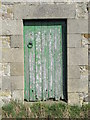 Green door in barn near Newbrough Hall