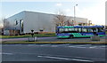 A Thamesdown bus passes a Next Home store, Swindon