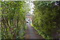 A footpath into a small housing estate