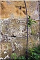 Weathered benchmark on St Michael & All Angels