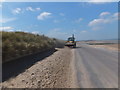 Clearing sand from the promenade