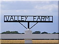 TM3283 : Valley Farm sign by Geographer