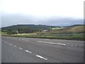 View SE from a layby on the A96 near Newton