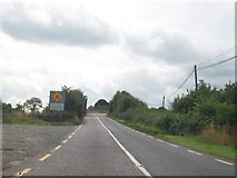 N0937 : The northern approach to the narrow bridge over the Dublin-Galway railway line by Eric Jones