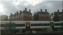 TQ2878 : South of Victoria station: Peabody Estate flats seen over a Brighton train by Christopher Hilton