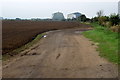 Freshly tilled field with a view of the sheds